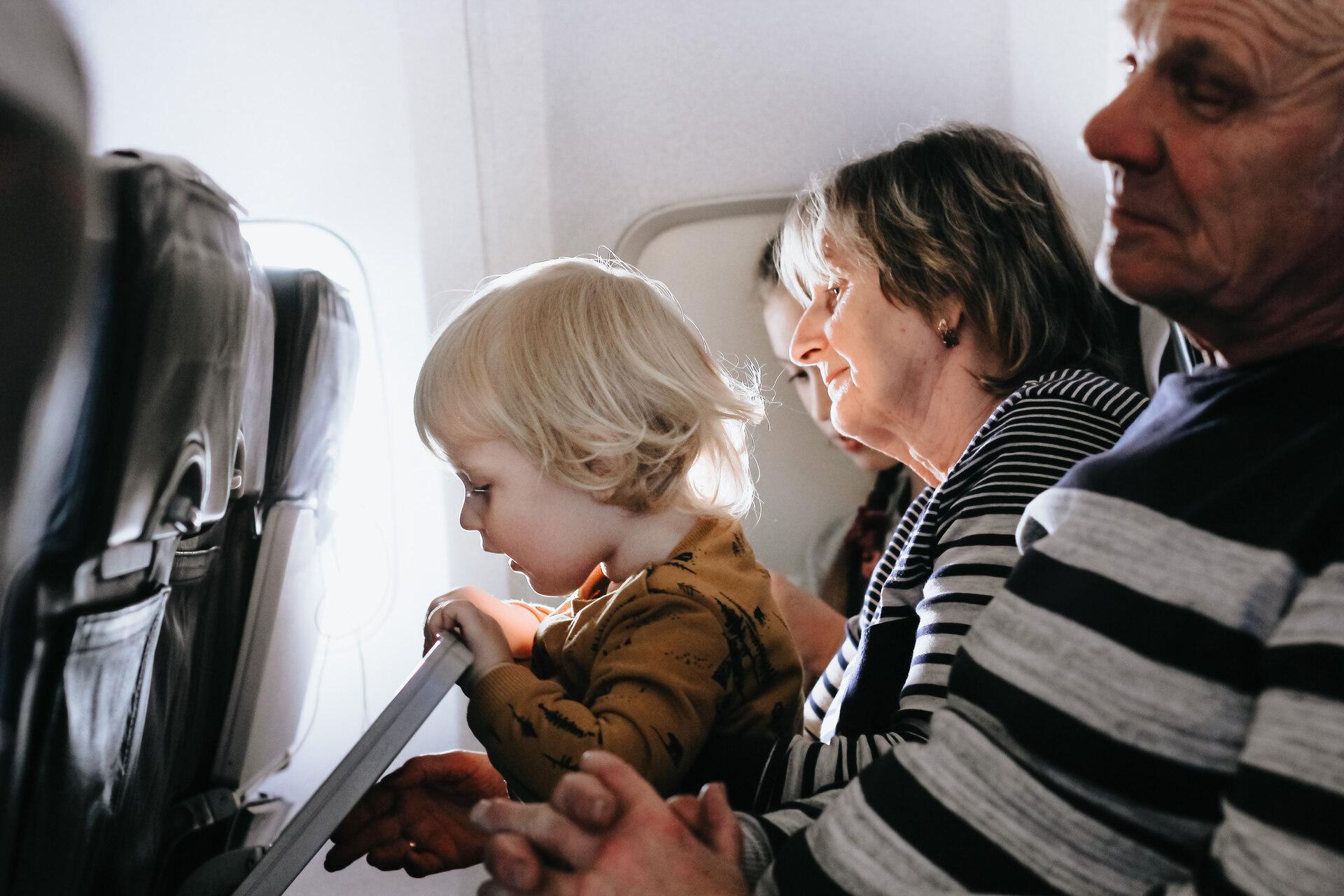 family sitting on a plane