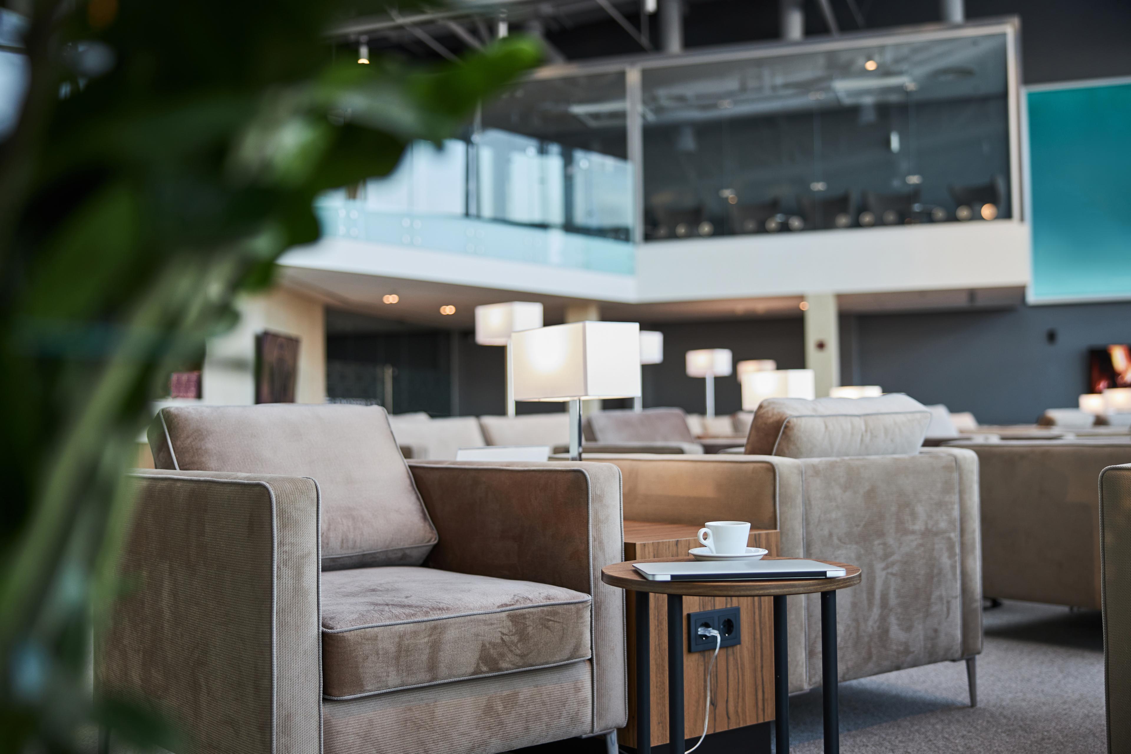 clean airport lounge with laptop and cup of coffee