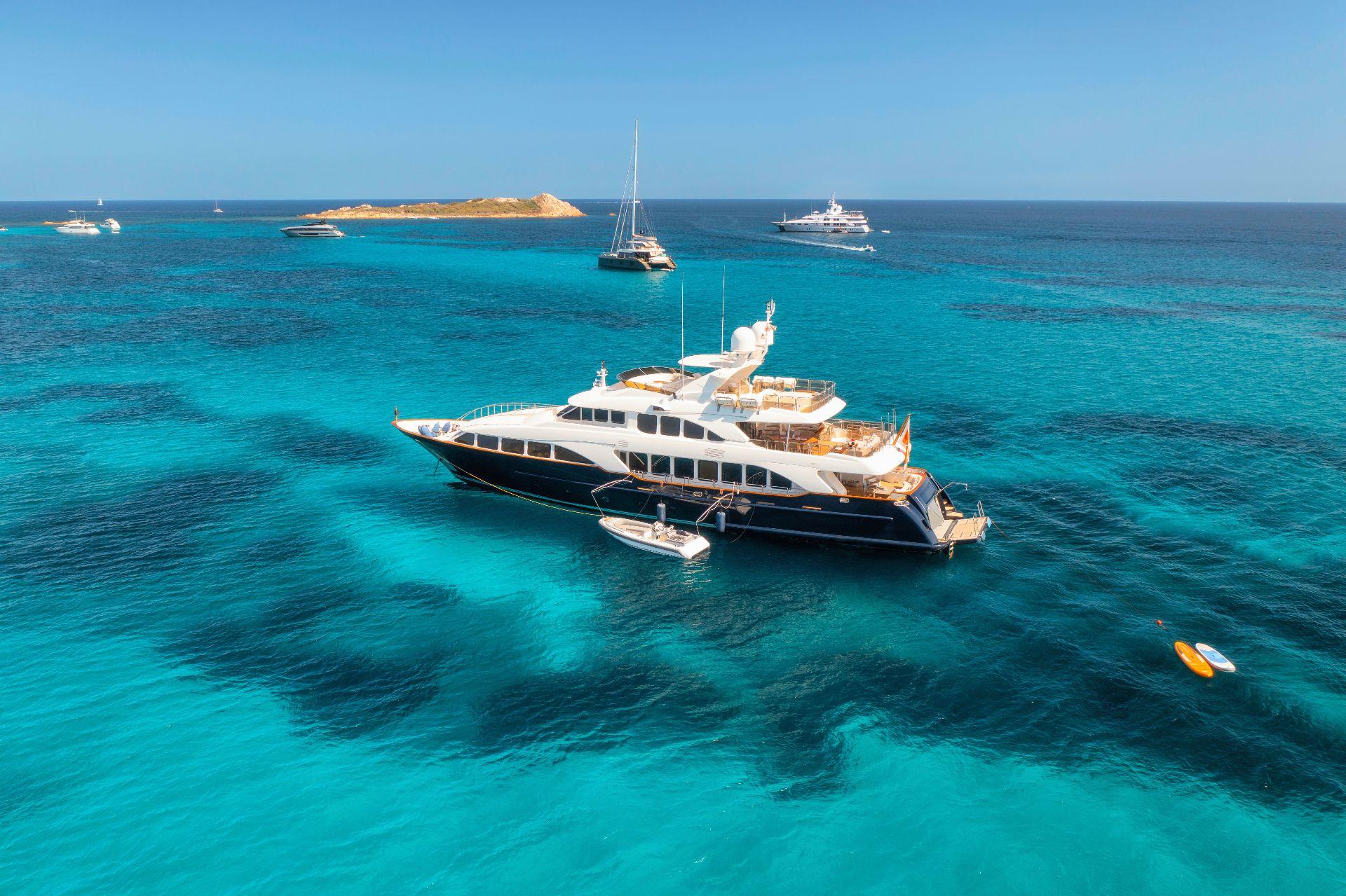 Luxury private yacht sailing through the clear blue waters of the Mediterranean