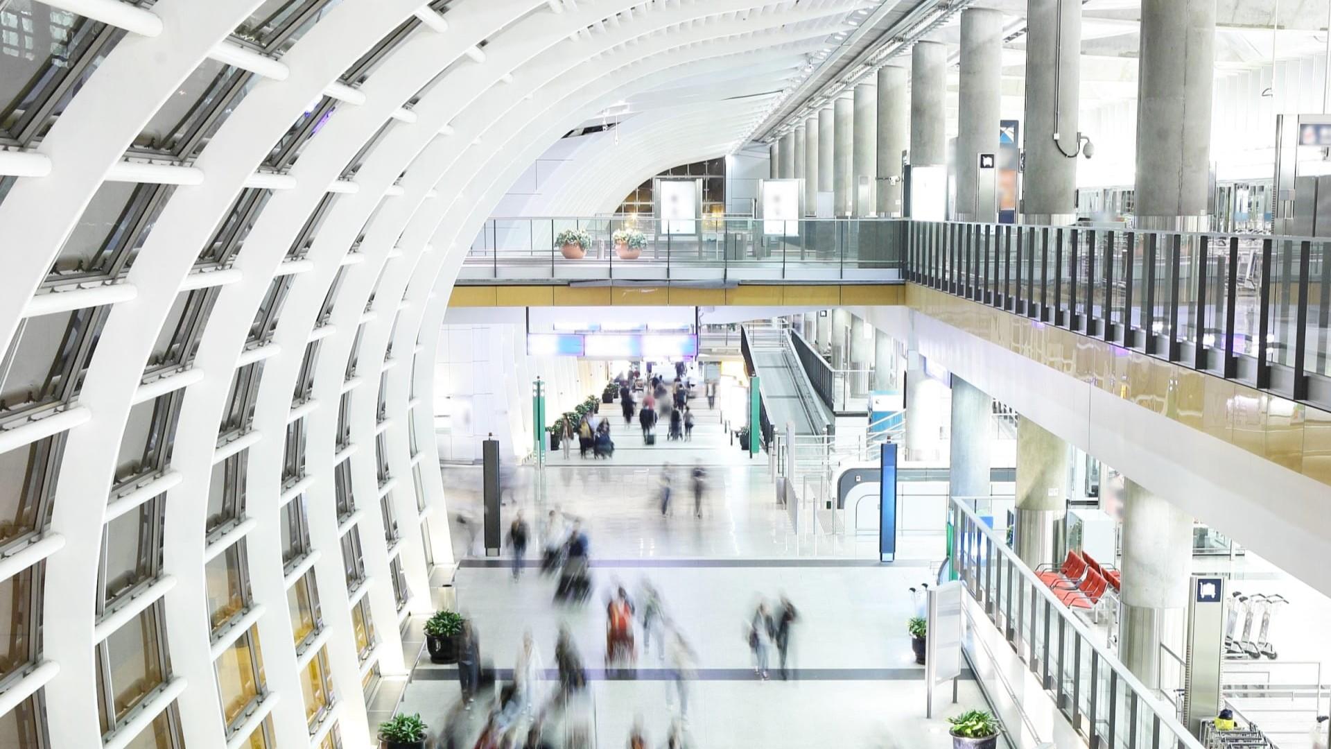 people at airport going through corridor
